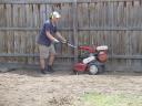 Chris tilling the ground with the rotary hoe